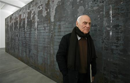 Artist Richard Serra poses for photographers beside one of his works entitled 'Fernando Pessoa' during the unveiling of his new exhibition at the Gagosian Gallery in London